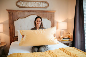 woman holding king sized pillow