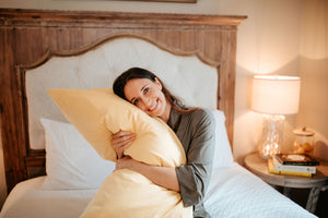 Woman hugging king sized pillow